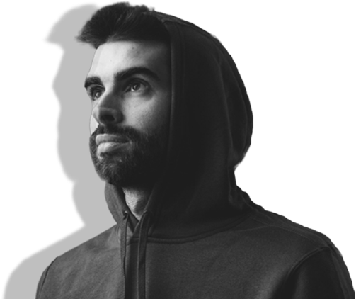 A black and white photograph of artist Sander Wolfs. He has short black hair and a beard, and is wearing a zip-up hoodie.